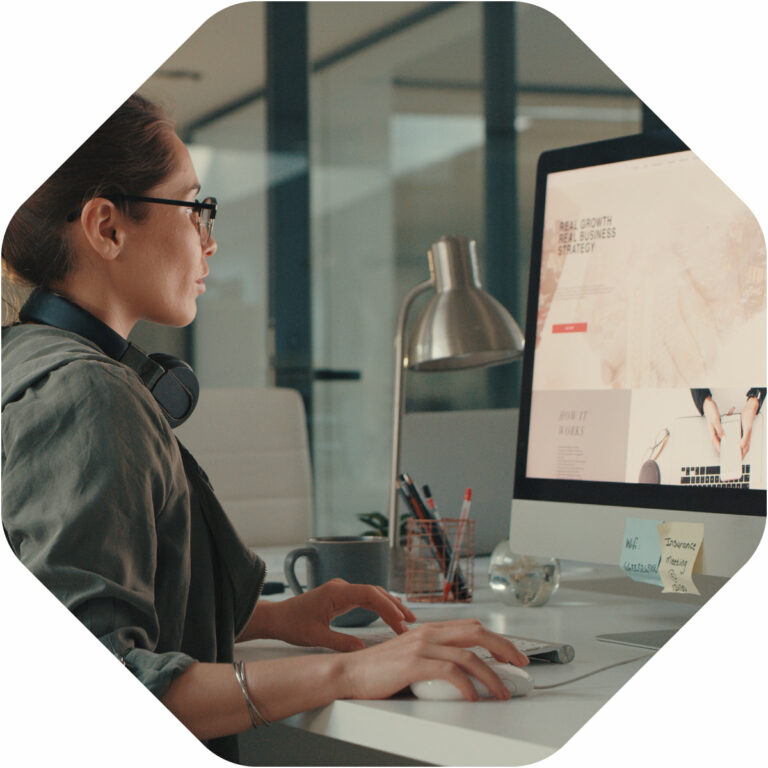 A woman working in front of her computer screen