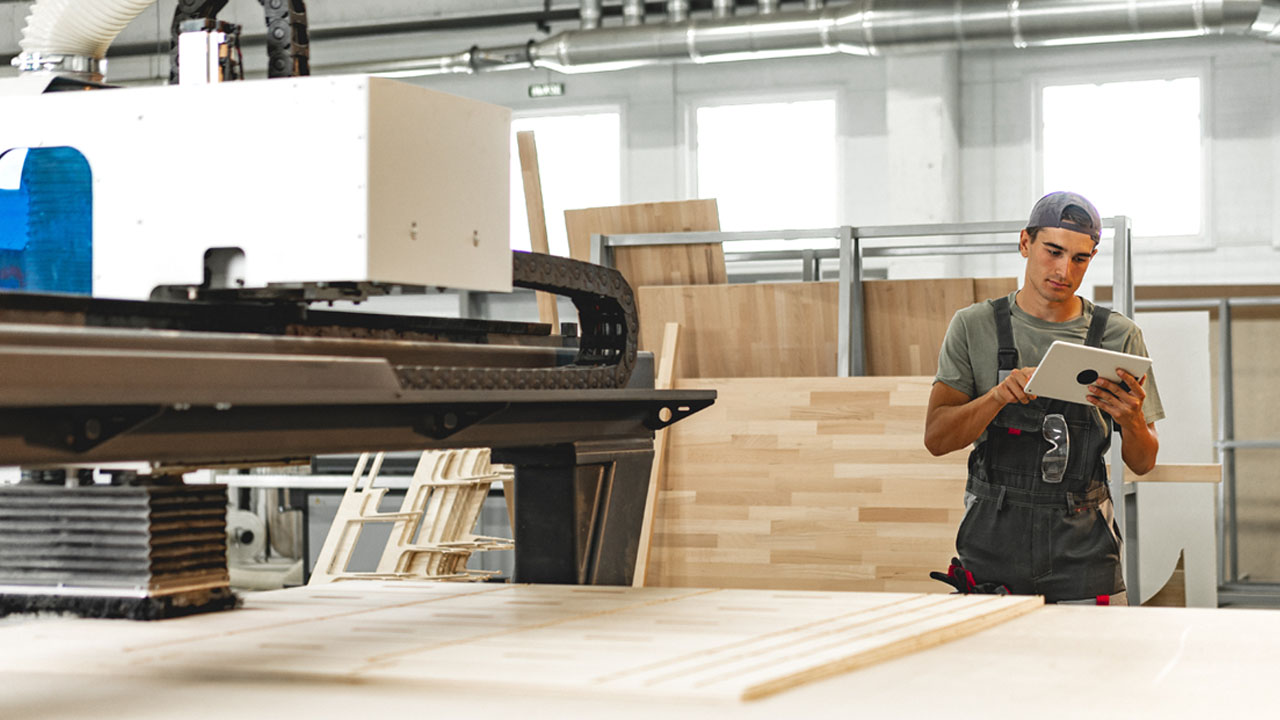 A man operating a woodworking machine.