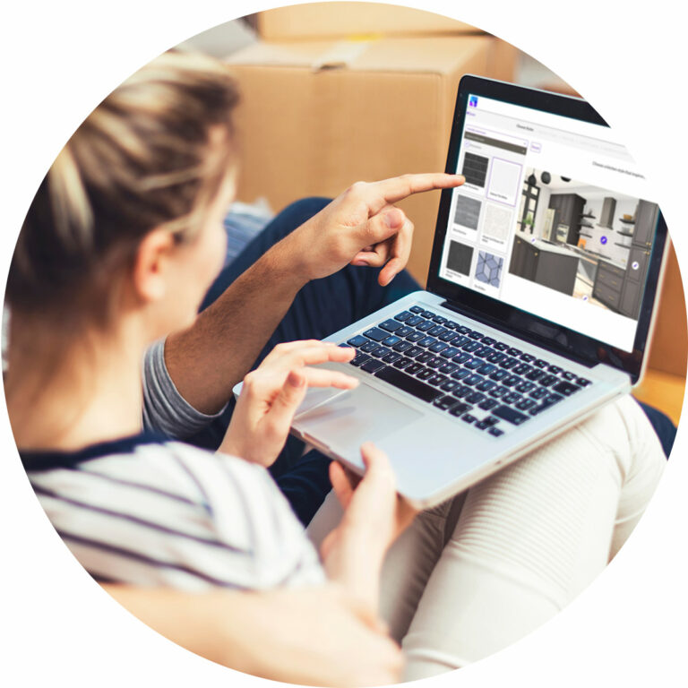 A woman and man sitting on a couch with a laptop.