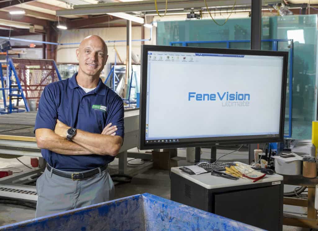 A man stands before a large screen displaying "FeneVision" logo