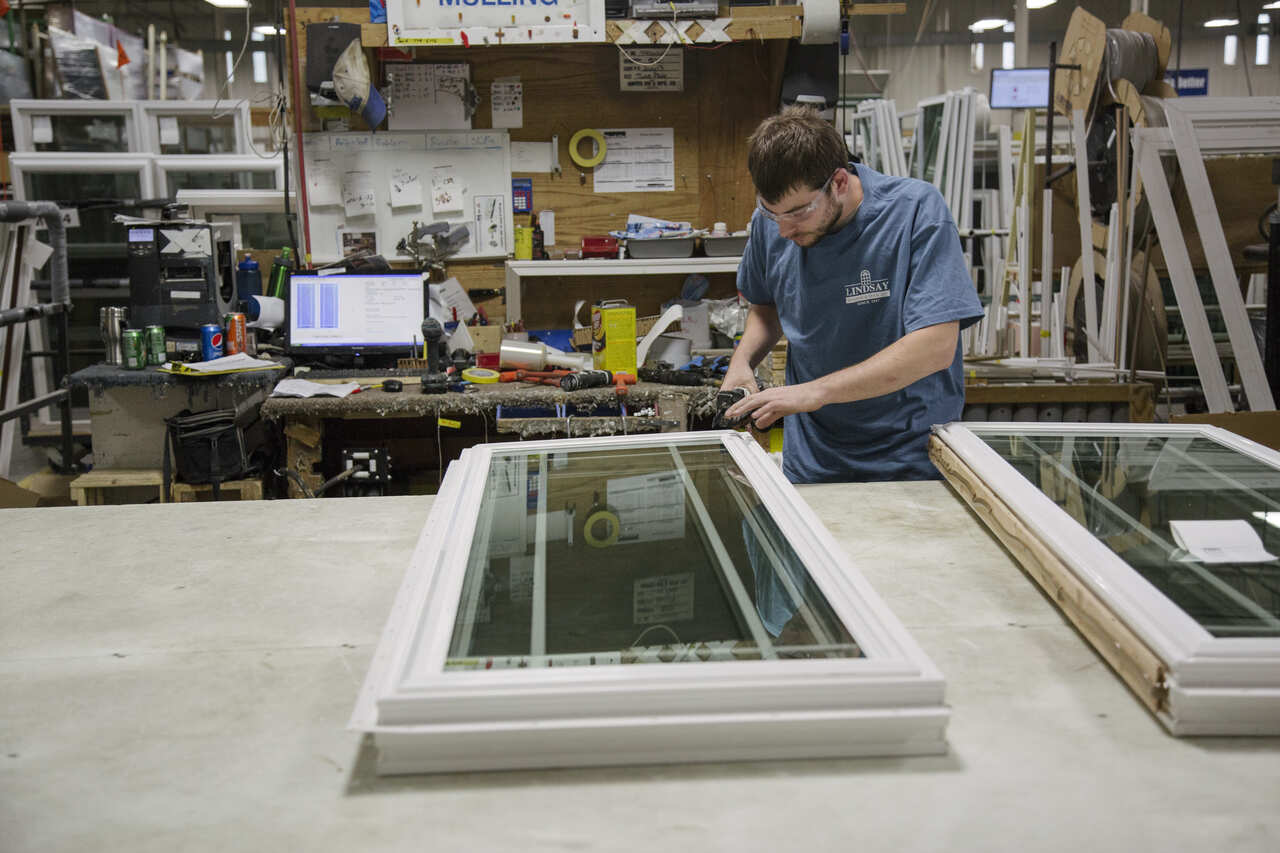 A man working on a factory window