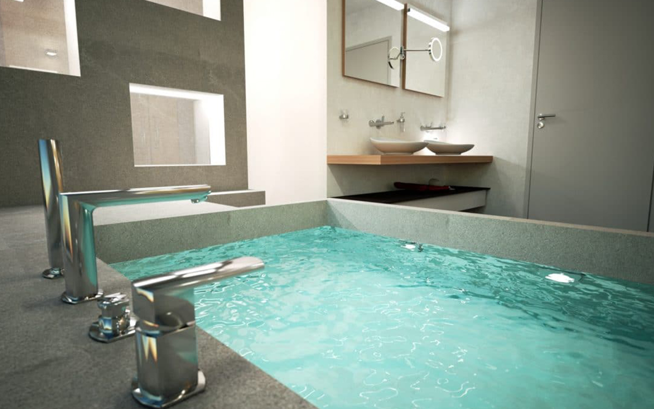 Close-up of a modern bathroom with a unique rectangular stone bathtub filled with clear water and stylish chrome faucets.