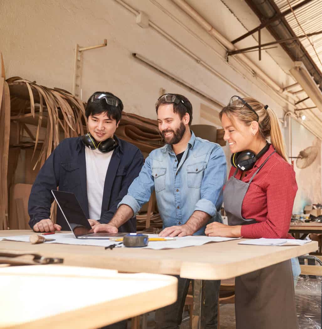 A team of three people in the workshop